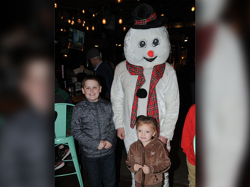 Frosty the Snowman put smiles on the faces of Robert Cole and Elizabeth Cole while they waited for the Christmas tree lighting in McCaysville.