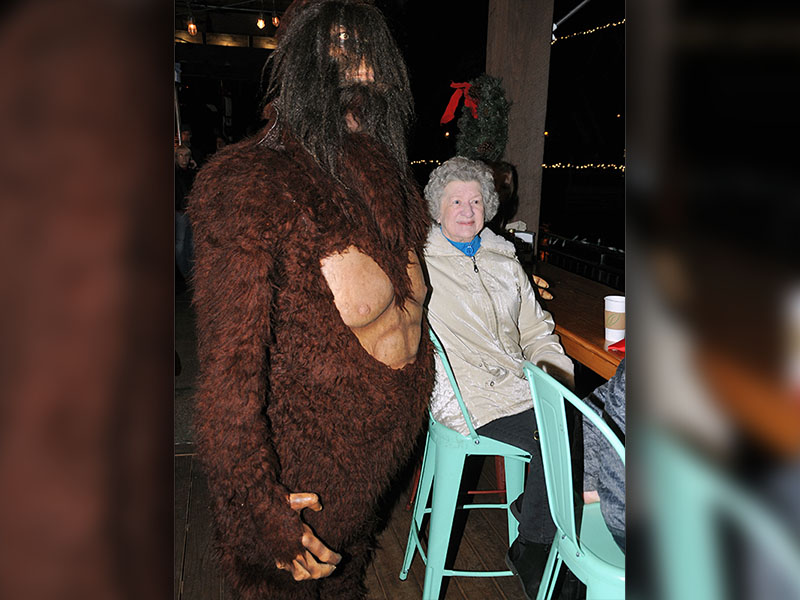  Betty Helton got a surprise visit from Big Foot while she waited for the Christmas tree lighting from the deck outside Burra Burra on the River.