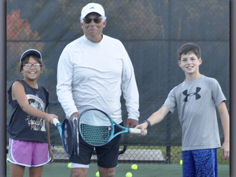 After their tennis lesson with Mel Locklear, from left, nine year old Ella Norris, Locklear, and 13 year old Garrett Pittman are all smiles at the Blue Ridge City Park Wednesday, November 10. 