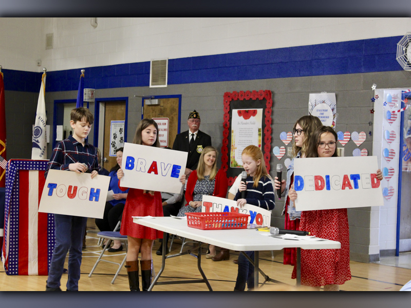 Blue Ridge Elementary School fifth grade students asked the question “What is a Veteran?” in their skit during the Veterans Day Ceremony November 10. Shown are, from left, Branson Ross, Olivia Hill, Aubrey Barton, Addyson Bradburn and Ruby Curtis as North Georgia Honor Guard Commander Bill Stodghill watches in the back. 
