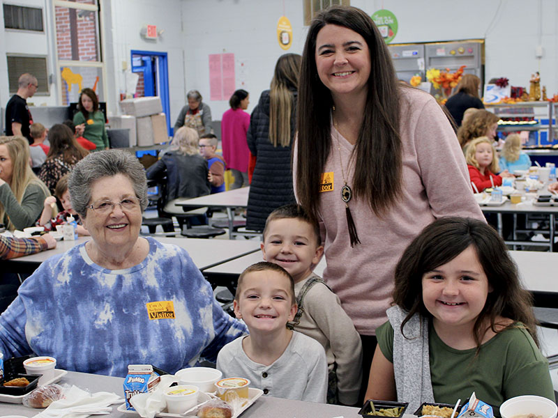 Mary Chancey, left, and Brittney Pittman, standing, joined East Fannin Elementary School students, from left, Brantley Pittman, Mason Pittman and Mallory Pittman, for a Thanksgiving meal Tuesday, November 16.   