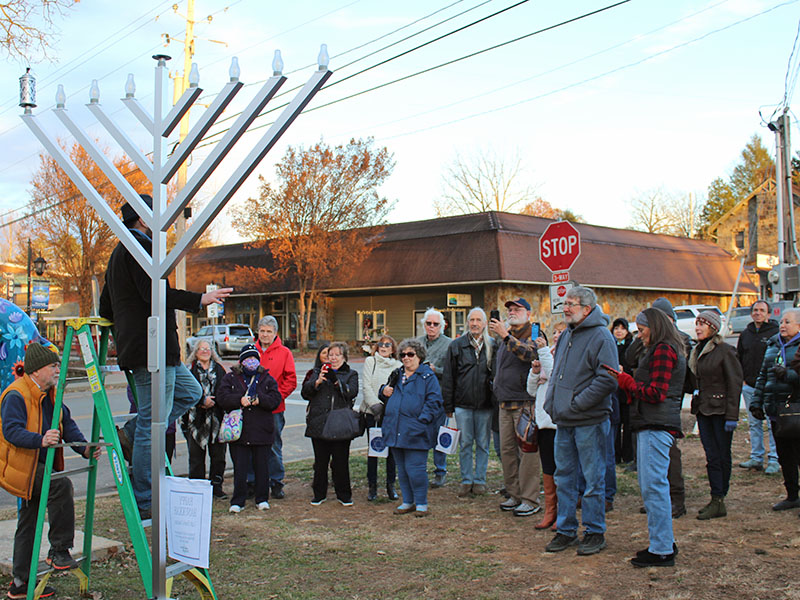 The Jewish Congregation of Blue Ridge met in front of the Daffodil Project Garden next to the park in downtown Blue Ridge where a public menorah was donated for the first night of Hanukkah Sunday, November 28. Each evening at sundown, the menorah’s electric candles will automatically light for each night of Hanukkah. There will be another gathering and lighting for the eighth and final night of Hanukkah Sunday, December 5, at 5 p.m.  