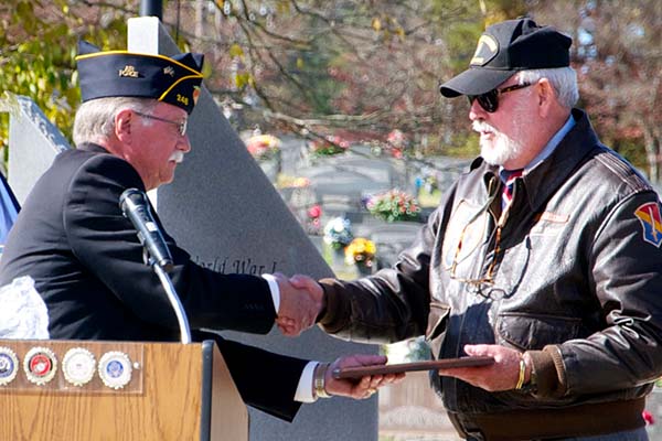 Veteran Bill Stodghill presents a plaque to fellow veteran Ben Arp, who was the keynote speaker during this year’s Veterans Day Ceremony at the Fannin County Veterans Memorial Park.