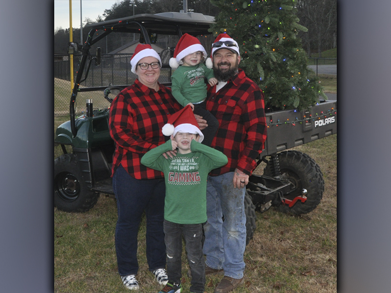 Families gathered at the Fannin County Recreation department fields Friday, December 3, to watch Santa Claus arrive by helicopter. Shown waiting patiently are, from left Elizabeth Bartlett, Creedence Bartlett and Ronald Bartlett holding Lauris Bartlett.