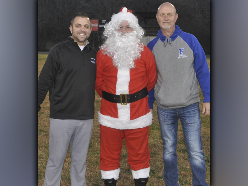 Santa was greeted by athletic coordinator Tim Towe, left, and Fannin Recreation Center Director Eddie O’Neal during the Winter Wonderland event held at the Fannin Coutny Recreation Center Friday, December 3. Santa was brought to the rec center by Blue Ridge Helicopter Tours for the second year in a row.
