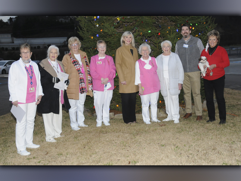 Braving the crisp weather, this group gathered to celebrate the Fannin Regional Hospital Auxiliary Love Light tree lighting December 7. From left are Jeane Bonnewitz, Joan Huddleston, Becky Guthrie, Barbara Cheatham, hospital Director of Volunteer Services Susan Kiker, Fannin Regional Hospital Auxiliary President Shirley Copeland, Laura Haight, Fannin Regional Hospital Chief Executive Officer Jason Jones, and Rita Oberle holding Sophie.