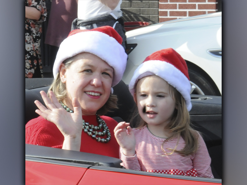 Copperhill Kiwanis Club Christmas Parade Grand Marshall Laura Crawford and a young friend wave to the crowd during the event Saturday, December 4. This marked the 62nd consecutive year for the annual parade.