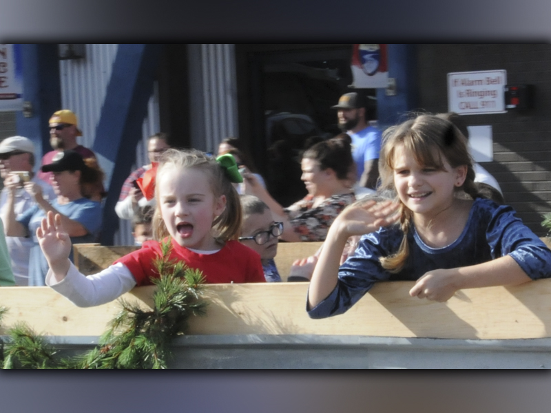 These youngsters help spread Christmas cheer as they throw out candy and yell “Merry Christmas” to a crowd along the streets in McCaysville and Copperhill.