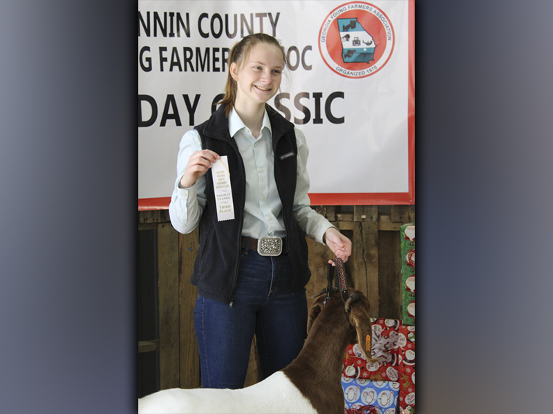 Abby McFarland showed her new goat, Barbie, in the Fannin County Young Farmers Association Breeding Ewe and Doe Holiday Classic, Saturday, December 4, where they won a third place ribbon in their weight class.