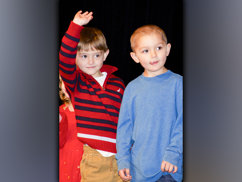 West Fannin Elementary School students Ezra Loudermilk, left, and Ayden Smith look out in the crowd for their family before performing during the White Christmas program.