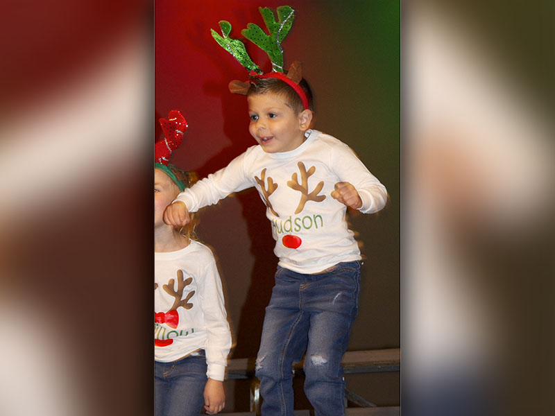 East Fannin Elementary School pre-k student Hudson Wright jumps in the air while performing the “Reindeer Hokey Pokey” during the schools Christmas performances Friday, December 17.