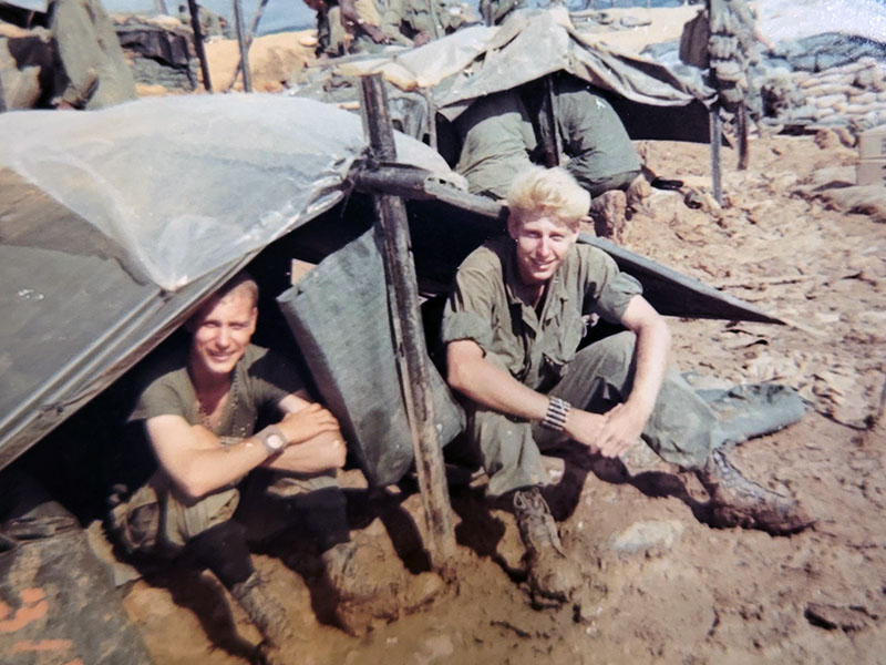 Floyd Ballance, right, is shown in between filling sand bags during his time overseas in the United States Army.
