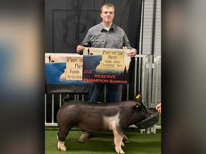 Shown is Slade Epperson, senior at Fannin County High School, with the hog he showed in the market hog show.