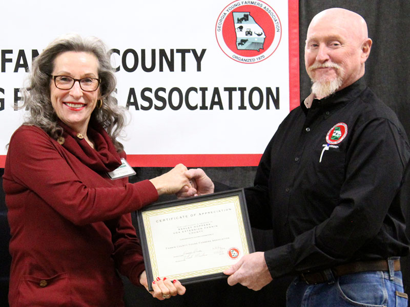 Marie Traylor accepts an award on behalf of The North Georgia Master Gardeners from FCYFA President Kenny Queen.