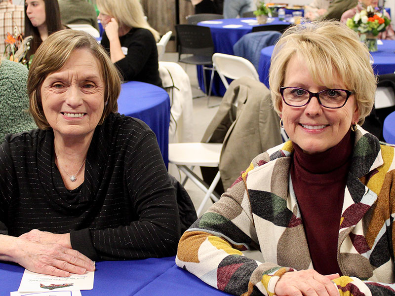 Instead of catching fish, Jan Hackett, left, and Executive Director of Fannin County Development Authority Sheree Ralston, catch up at the Back the Brookies Winter Bash hosted by the local Blue Ridge Mountain Trout Unlimited (BRMTU) chapter Saturday, January 29.