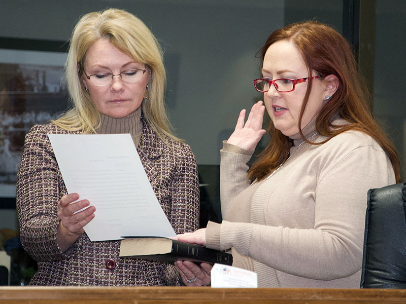 Laura Ray, right, takes her Oath of Office for the Blue Ridge Downtown Development Authority while Mayor Rhonda Haight holds the oath and Holy Bible.