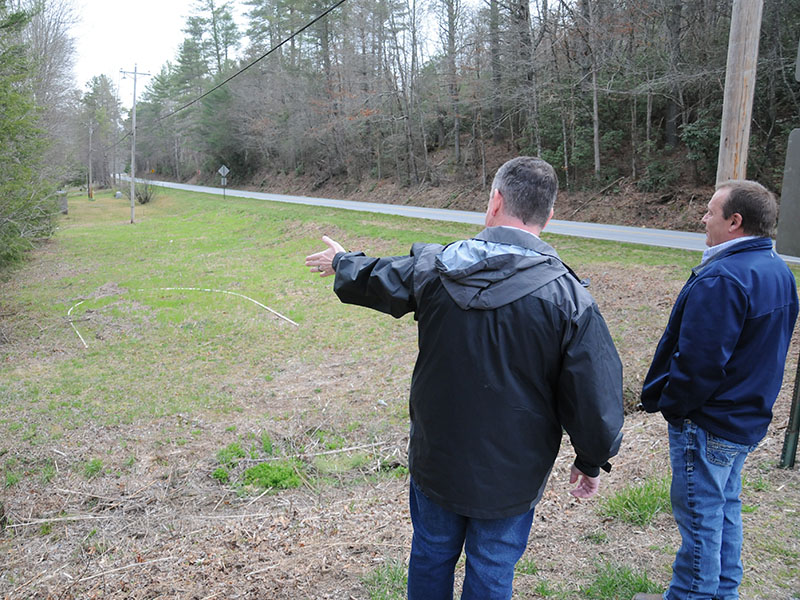 Fannin County Commission Chairman Jamie Hensley, left, and Public Works Director Zack Ratcliff look over the area upstream and adjacent to Shallowford Bridge that will be turned into parking and provide river access. Work to prepare the parking area will be completed by county crews while a local Boy Scout will be building steps to access the Toccoa River for his Eagle project.