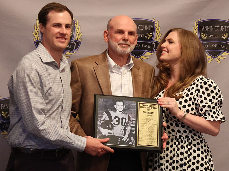 Inductee Don Clement, middle, accepted his plaque with his son Landon, left, and his daughter Leia, right, at the Sports Hall of Fame Ceremony April 9. 