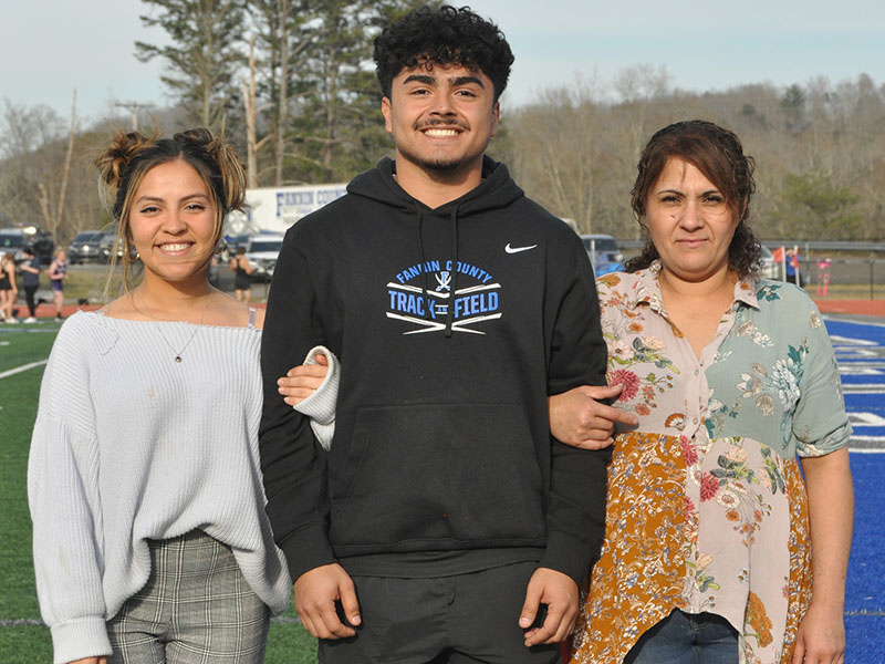 Senior Ricardo Arellanes was escorted by his sister Michell Arellanes, left, and his mother Hidolina Arellanes. 