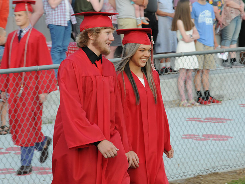 Eli White and Sydney Hickey are all smiles as they enter the Copper Basin High School graduation ceremony.