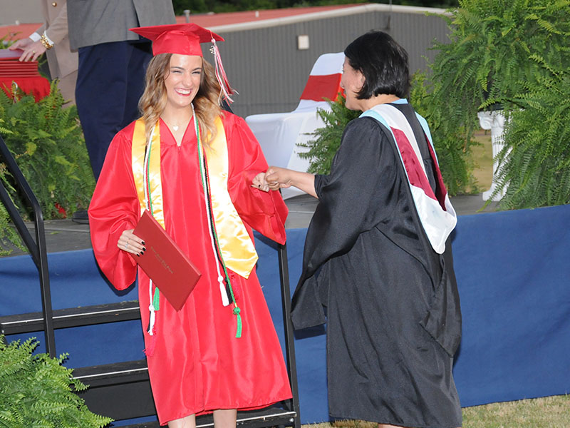 Copper Basin High School graduate Maleia Bigham receives a congratulatory fist bump from Zulma Youngs after receiving her diploma Friday night at Copper Basin. For more coverage from the event, please see page A4.