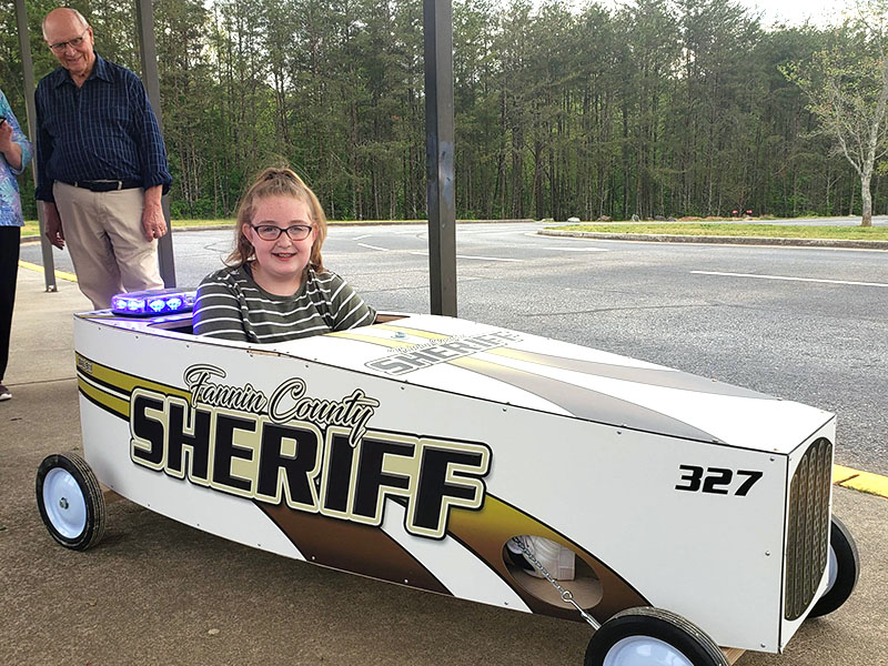 Skylar Gazaway piloted the Fannin County Sheriff’s Office car in the Blue Ridge Soap Box Derby. On the front is her dad’s, Richard Gazaway’s, badge number, 327.