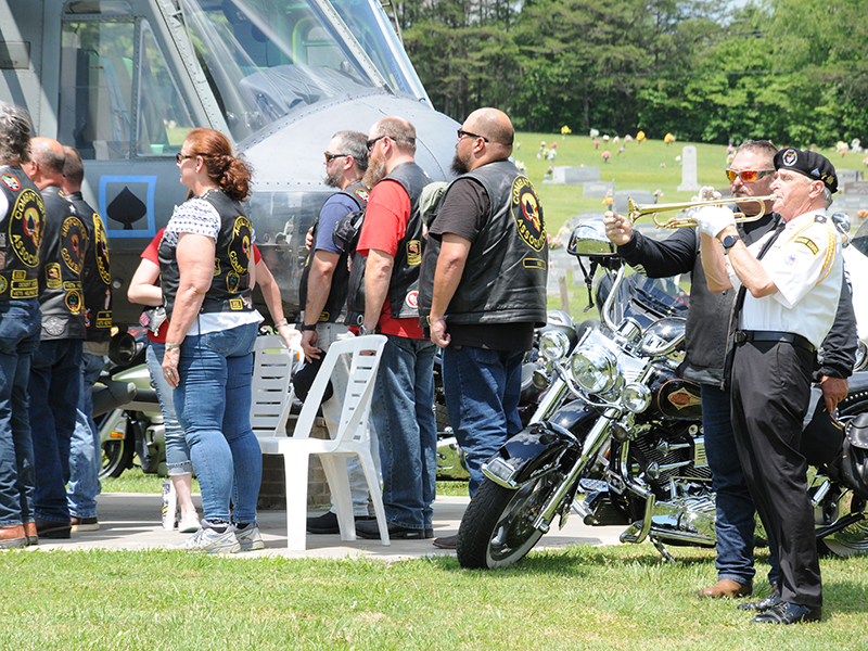 Members of the Combat Veterans Motorcycle Association listen as Taps is played to conclude the Memorial Day service at Veterans Memorial Park.