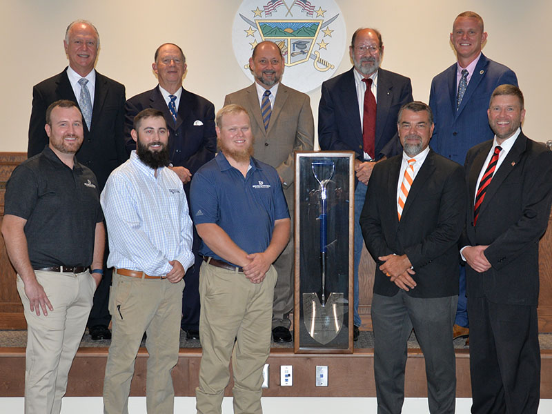 The Fannin County Board of Education was presented a framed, engraved silver shovel by the contractors to represent the completition of the new Fannin County School System Staff Development Center. Those taking part in the ceremony were, from left, contractors Alex Klienert, Tanner Holcomb, Mathew Wyatt, Associate Superintendent for Planning and Operations Darren Danner, School Superintendent Dr. Michael Gwatney, and, back, board members Terry Bramlett, Bobby Bearden, Mike Cole, Lewis DeWeese, Chad Galloway
