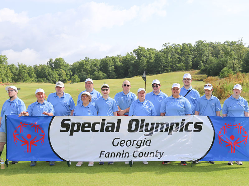 Fannin County Special Olympic participants smile at the Golf Skills event at Old Toccoa Farm Tuesday, July 19. Shown are, from left, Brandon Craig, Jay Jenkins, Kevin Turner, Kari Castlen, Rick Kruse, Alex Hughes, Tommy Cornett, Eric Morris, Michael Elliot, Amanda King, Riley Post, Jonathan Waters and Ansley Price.