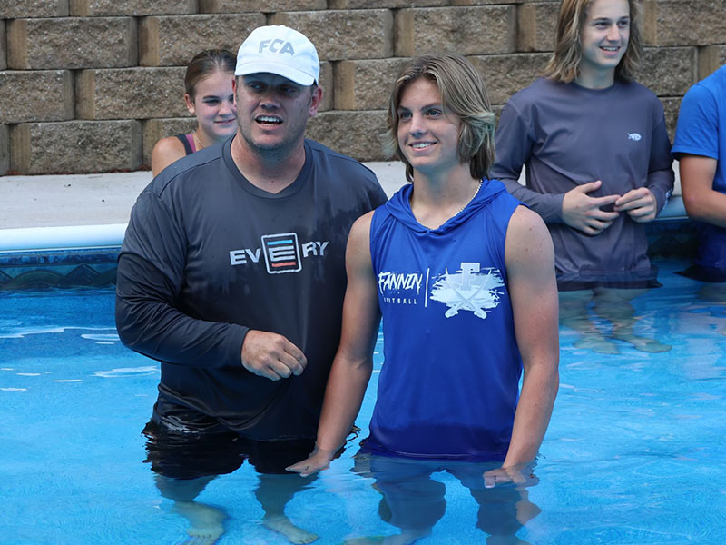 Lawson Sullivan, right, shows his excitement by smiling wide as Matt Queen, left, explains the profession of faith by baptism. 