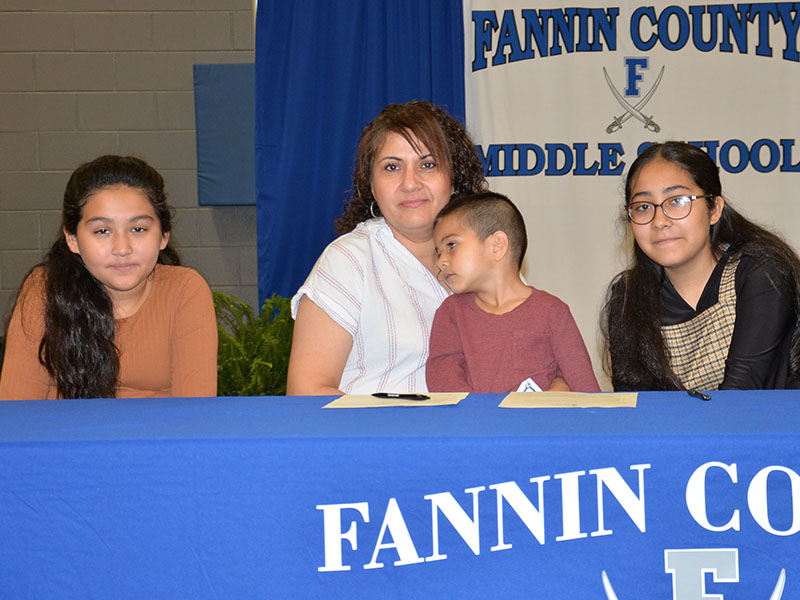Lesly Alvarado, right, is one of this year’s REACH scholars at Fannin County Middle School. Her mom, Hidolina Alvarado joined her in her contract signing along with Camila Alvarado, left, and Sebastian Alvarado.