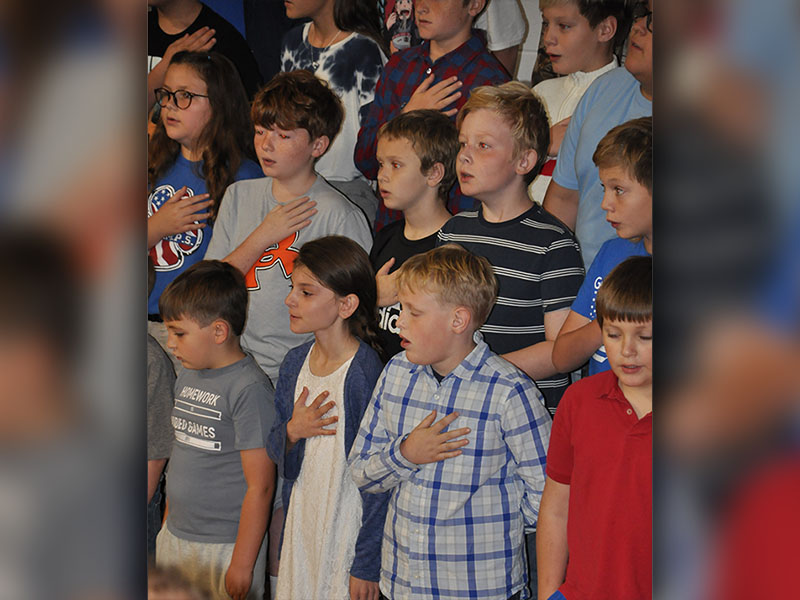 Students are shown singing the National Anthem during East Fannin Elementary School’s (EFES) Veteran’s Day Program November 9. Front row, from left, are EFES students Landon Graham, Karrissa Martin, Ty McClure and Ryan McGillis. Next row, from left, are Emmalynn Dye, Cooper Highley, Cullen Kimsey, Ricky Davis and Yates Eavenson.