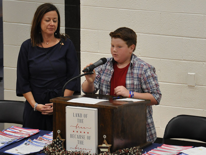 Pictured are West Fannin Elementary School student Jonah Strobel and Principal Alison Danner. Strobel is shown leading his fellow students in the Pledge of Allegiance during their Veteran’s Day Program November 9.
