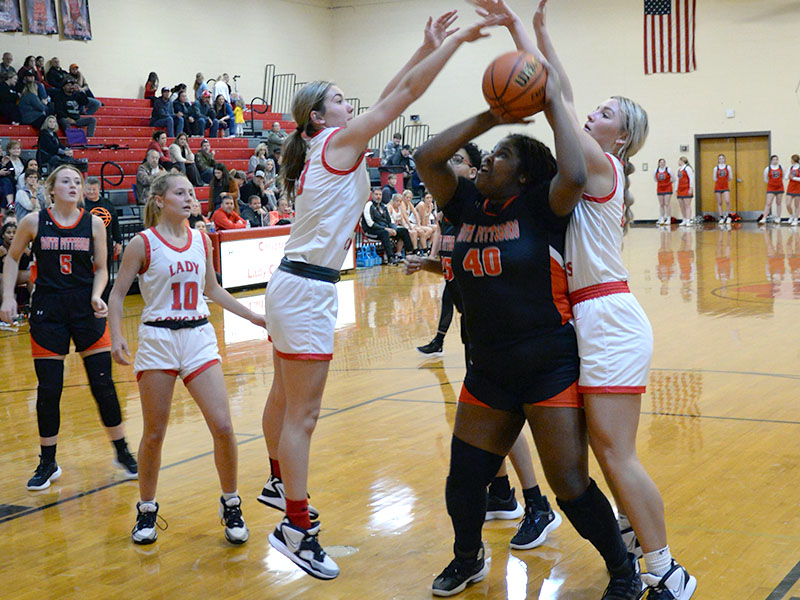 Zoe Green, left, and Sapporiah Ross, right, get big for Copper Basin to to block a shot attempt against the South Pittsburg Lady Pirates. 