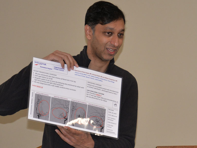 Dr. Rishi Gupta displays the poster created for Kennestone Hospital’s Comprehensive Stroke Center after a partnership involving a Fannin County EMS crew, Life Force, and Kennestone Hospital resulted in an 88-year-old stroke patient’s miraculous recovery.