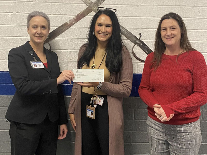 Martha Williams, from left, presented a Farm to School grant check to Kristen Stone and Amy Adams at Fannin County High School.