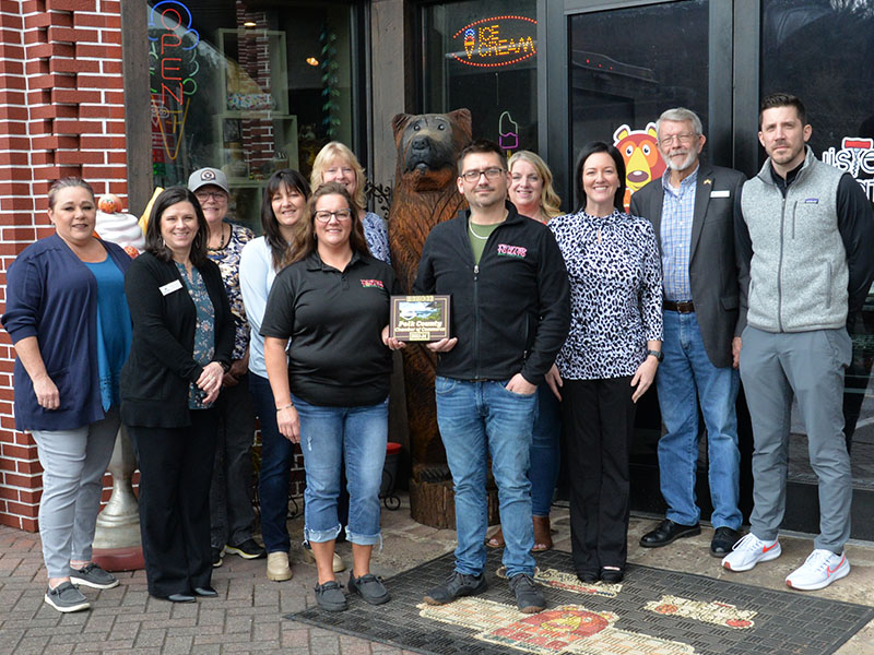 Heather Hawkins and Jesse Hawkins proudly show off their plaque recognizing Happy Bear Ice Cream as a new member of the Polk County Chamber of Commerce. The plaque was presented by Chamber representatives, from left, Kat Yoeman, Jenny Munty, Colleen Fults, Sarah Berry, Ellen Raper, Lynne McClary, Amanda Hill, James Woody, and Byran Clary during a special last Thursday in McCaysville.