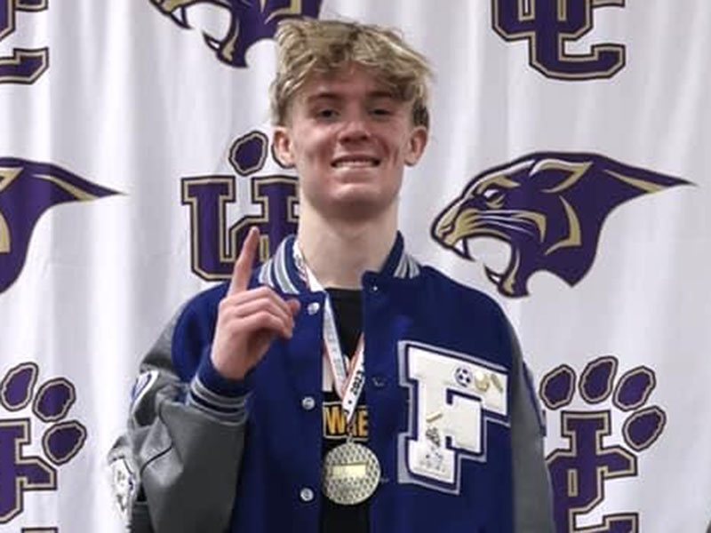 Fannin County junior Blake Summers stands on the first place podium after his 100th varsity win for the Area Championship Saturday, February 4, at Union County High School.