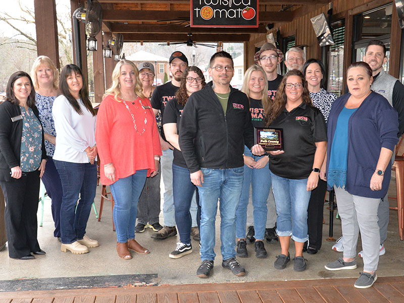 Four Copper Basin area businesses in McCaysville located in the Riverwalk Shops complex were welcomed as members of the Polk County Chamber of Commerce last week with plaque presentations. Among those was Twisted Tomato. Shown areChamber representatives Jenny Mundy, Ellen Raper, Sarah Berry, Lynne McClary, Colleen Fults, Twisted Tomato Manager/Executive Chef Jesse Hawkins and Assistant Manager Heather Watkins, with employees Mikaela, Tori, Zac and Kenny, and Chamber representatives James Woody, Amanda Hill,