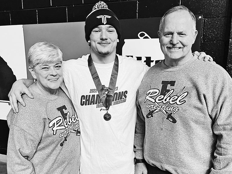 This picture shows Doug and Marsha Davenport celebrating with their grandson Corbin after his state wrestling championship in 2023. 