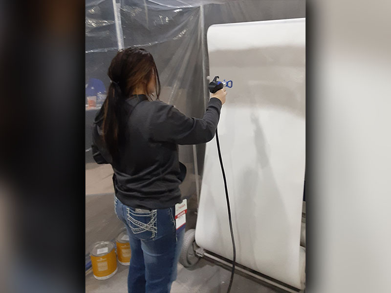 Chelsey Frye works on a painting project at the SkillsUSA state conference in Atlanta.