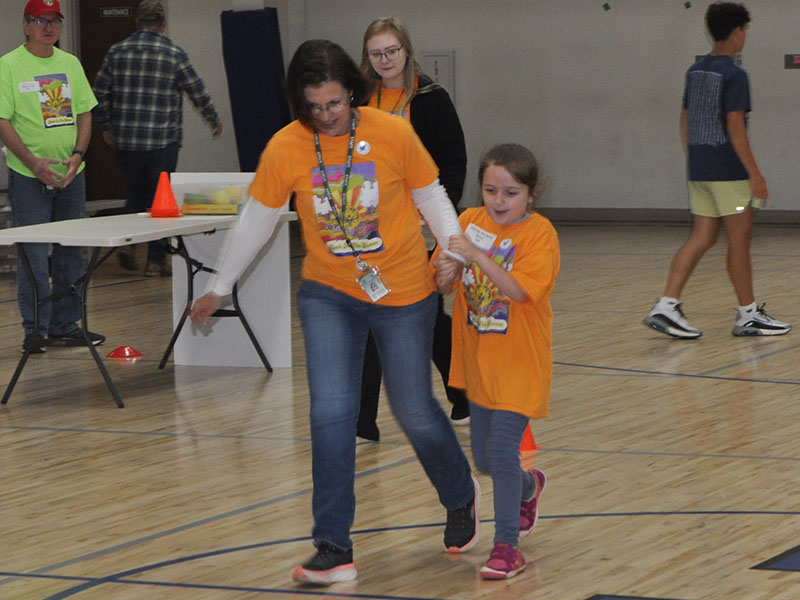 Corrie Cochran from Mountain Area Christian Academy (MACA) gets a little help racing to the finish line from MACA staff member Kim Thomas. The Special Olympics Track and Field event was moved indoors to the Fannin County Recreation Department last Friday due to the threat of rain.