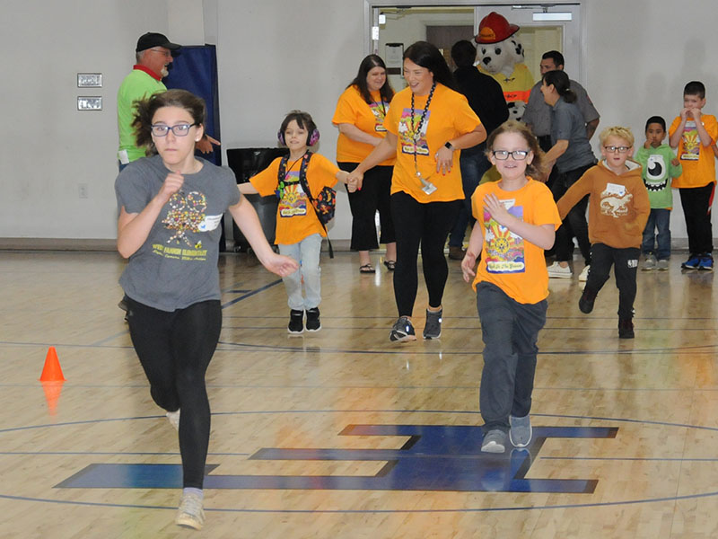 The race is on between West Fannin Elemntary’s Christina Evans, Artemus Fowler, Ezra Lee and Kaiden Tucker as West Fannin parapro Stephanie Fink lends a helping hand during Special Olympics Track and Field events last week.