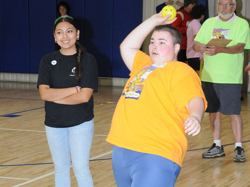 Ethan Firestone from Fannin County High School attempts the winning throw during the Special Olympics Track and Field event as Isabel from the FCHS Partners Club looks on.