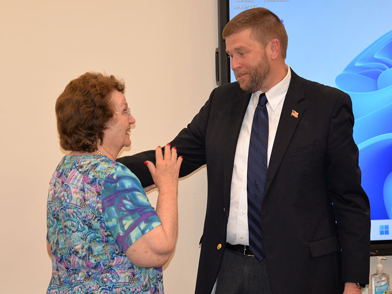 Faye Sisson extends congratulations to Dr. Michael Gwatney at his retirement reception last week.