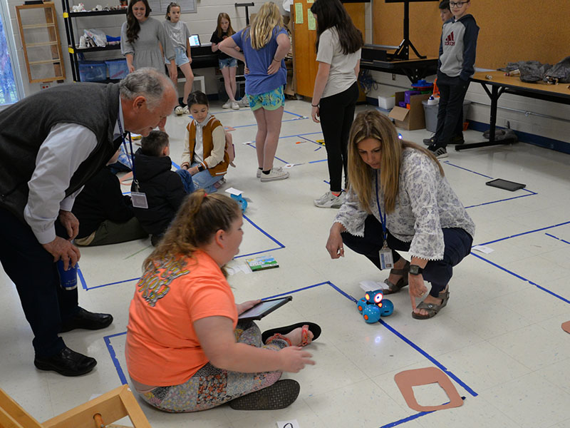 Board of Education Chairman Terry Bramlett, from left, gets a lesson in robotics at East Fannin Elementary from Katie-Ann Tipton and Robin Stephens. The demonstration was part of the school board’s Spring Local Board Training.