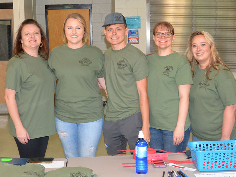 Dawn Cochran, Lauren Watkins, Stephen Dickey, Sarah Dickey and Kim Callihan, from left, were busy coordinating Riding the Ridge Saturday morning at Fannin County Middle School. A total of 44 Jeeps were signed up to participate in the event that traditionally kicks off fundraising for Shop With a Cop.