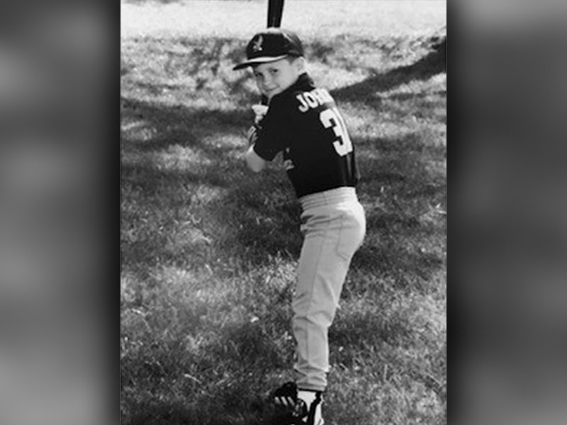 A young Jordan Farmer is shown batting for a photo. 