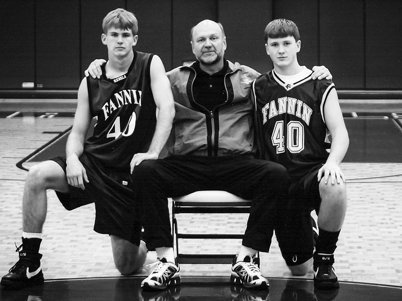 Jordan Farmer, right, is pictured with his father Johnny, center, and brother Jonathan, left, at the Fannin County High School gym. 