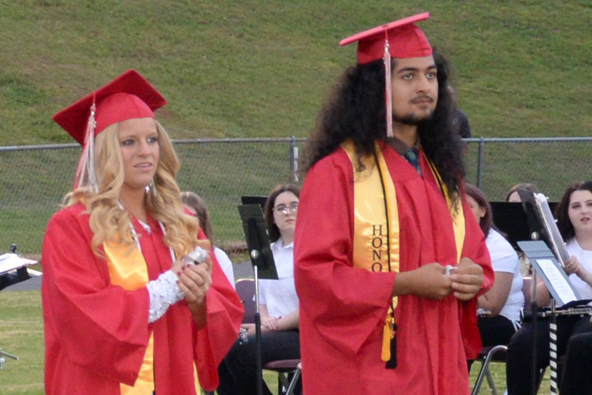 Destiny Pittman and Krus Soto wait to receive their high school diplomas.